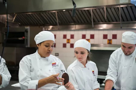 ICE pastry students pass around a cacao pod as they study bean-to-bar chocolate making